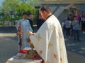 Cleric with cloak polishing golden chalice before the ritual at the church